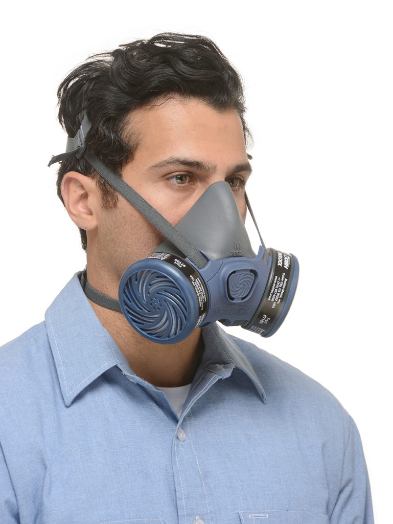 view from the side of a man wearing half-face reusable respirator mask