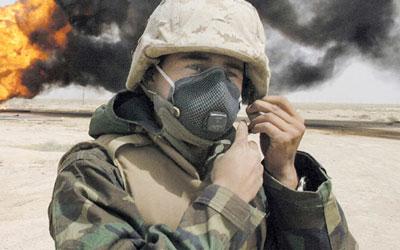 soldier putting on respirator face mask during fire