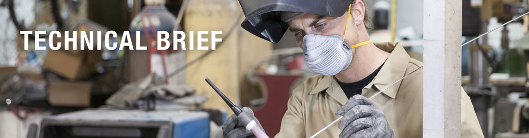 welder wearing fully disposable respiratory face mask in work area