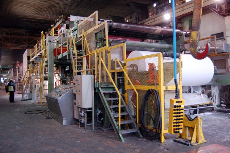 man operating large scale printing press